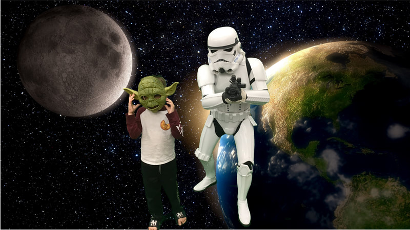 A child with a Yoda mask and a storm trooper pose in front of the Earth seen from space.